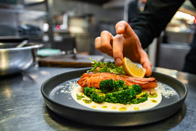 A chef plating up a salmon dish