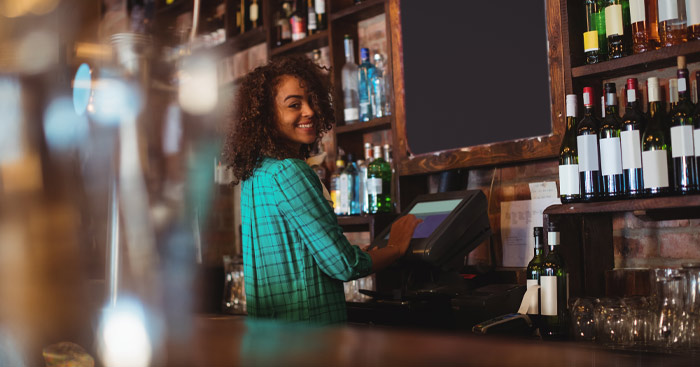 A woman working behind a bar